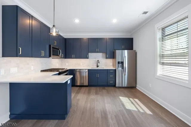 a kitchen with a sink a stove and cabinets