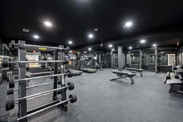 a view of an empty room with kitchen view