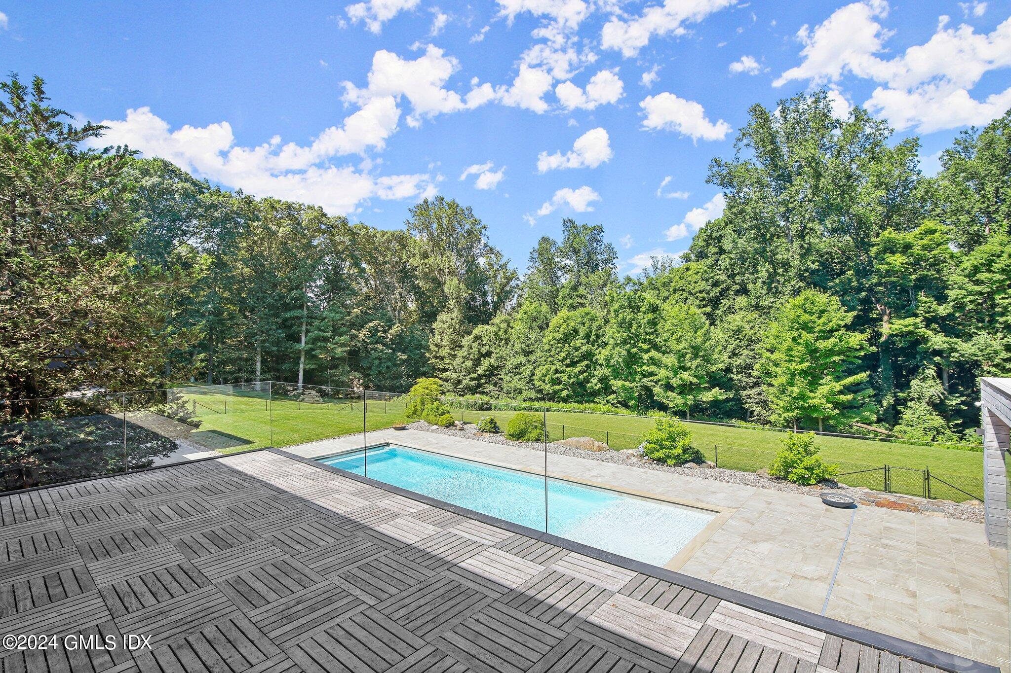50 Sumner Road Greenwich, CT 06831 - Photo 38 of 69 a view of a yard with swimming pool and green space