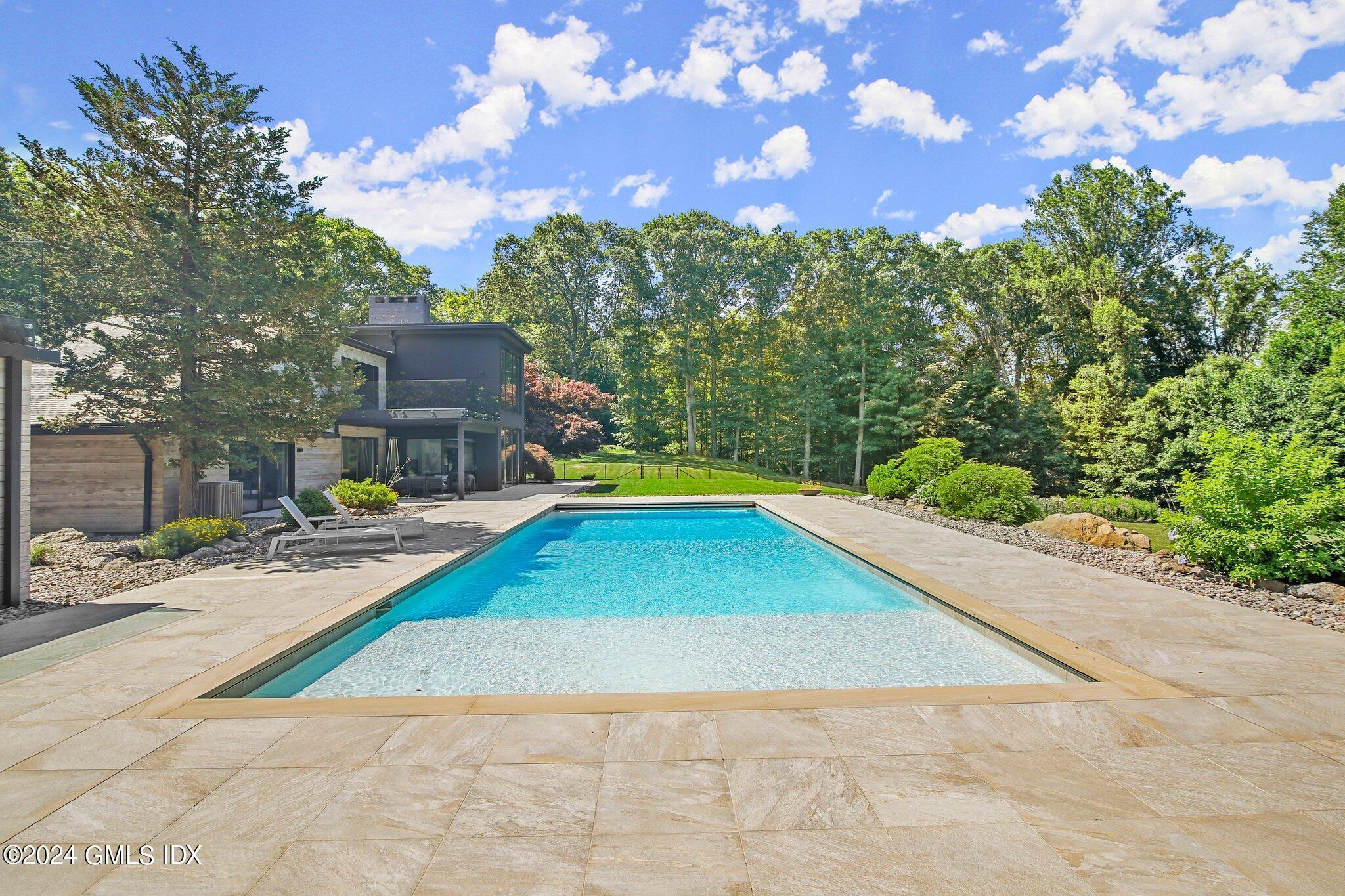 50 Sumner Road Greenwich, CT 06831 - Photo 54 of 69 a view of backyard with swimming pool and seating space
