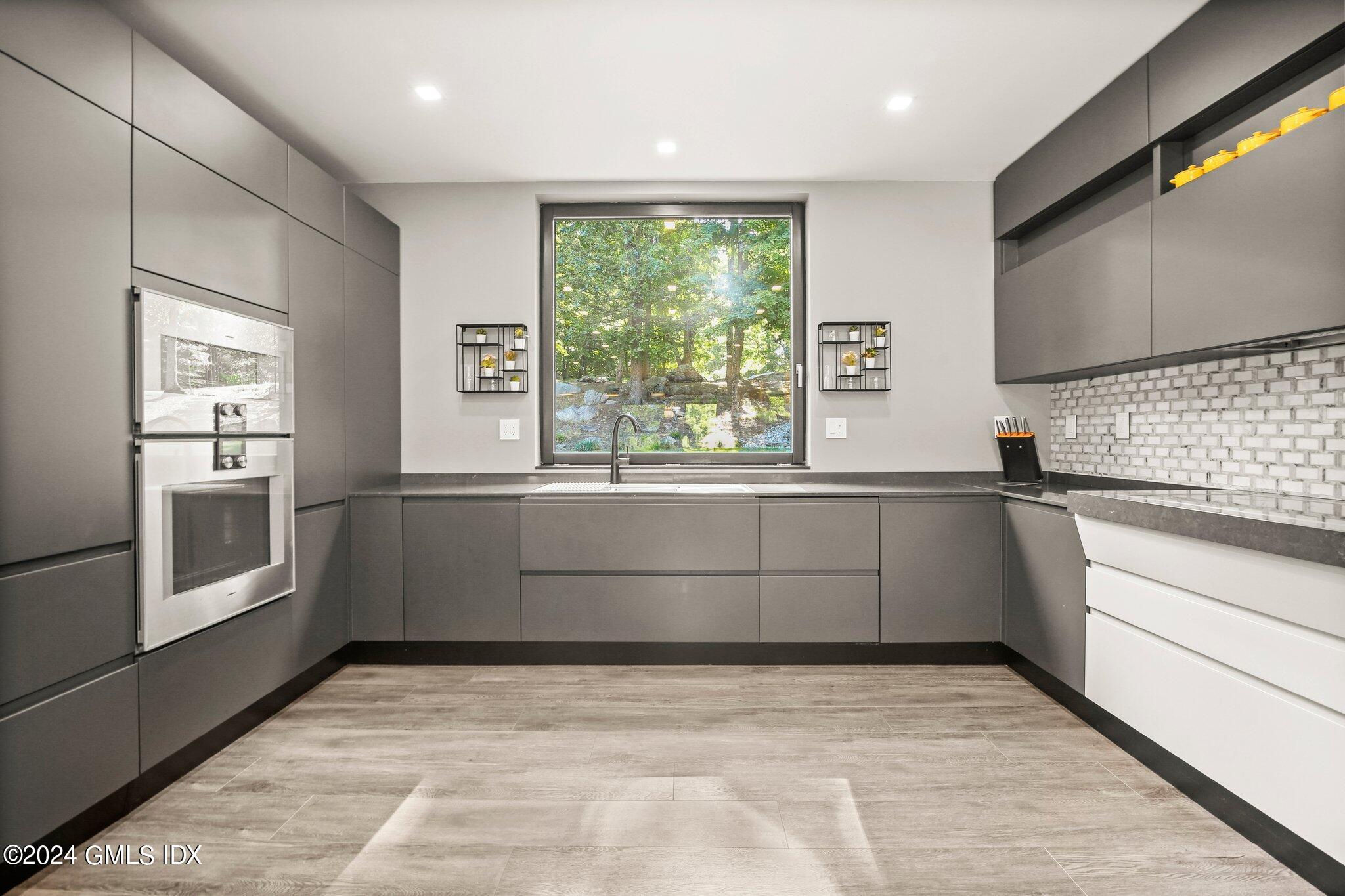 50 Sumner Road Greenwich, CT 06831 - Photo 8 of 69 a kitchen with a sink and a large window
