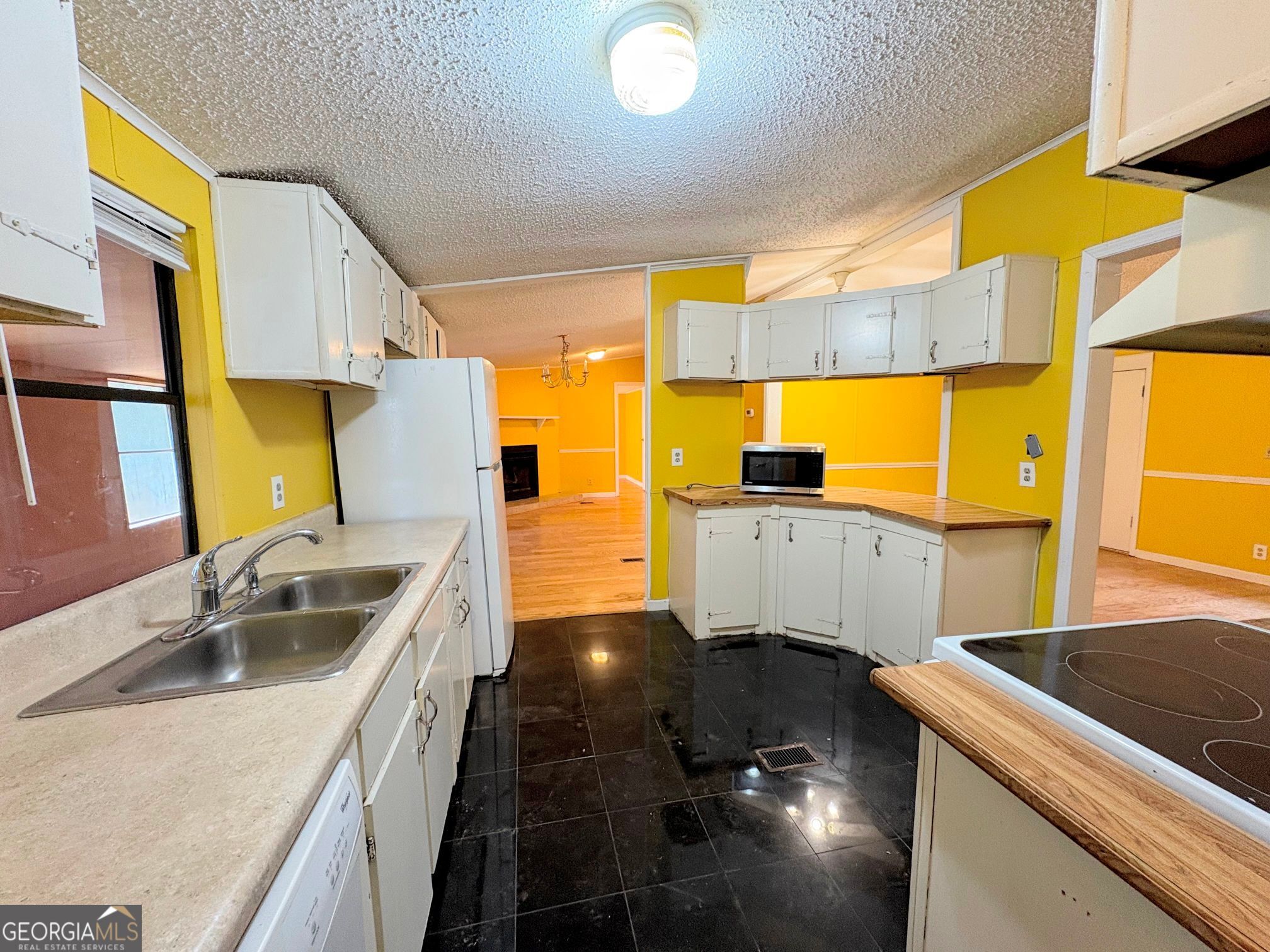 319 Wages Road Auburn, GA 30011 - Photo 11 of 26 a kitchen with stainless steel appliances granite countertop a sink and a stove next to a window