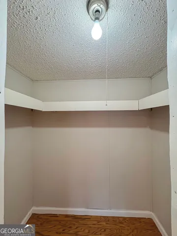 a view of a room with wooden floor