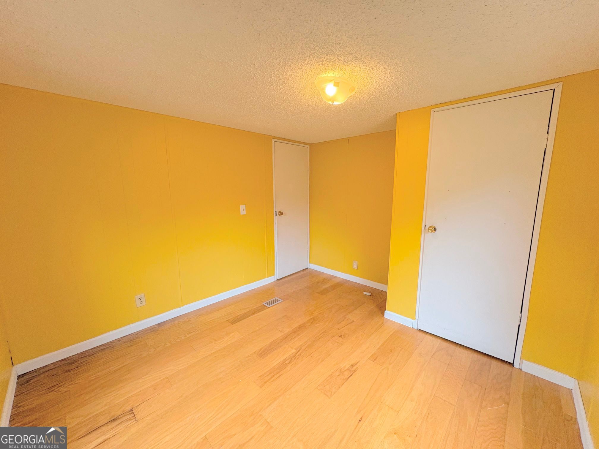 319 Wages Road Auburn, GA 30011 - Photo 21 of 26 a view of empty room with wooden floor