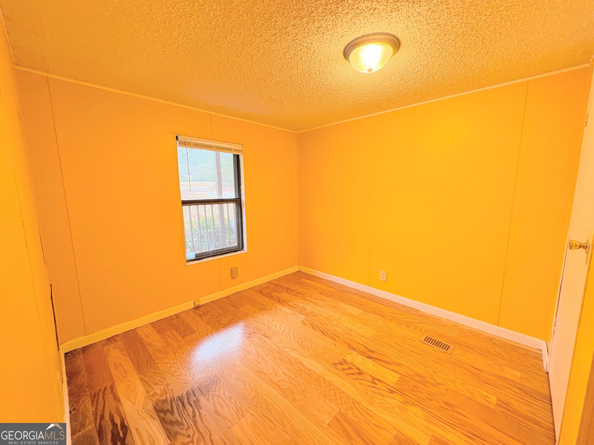 319 Wages Road Auburn, GA 30011 - Photo 24 of 26 a view of a room with a wooden floor and a window