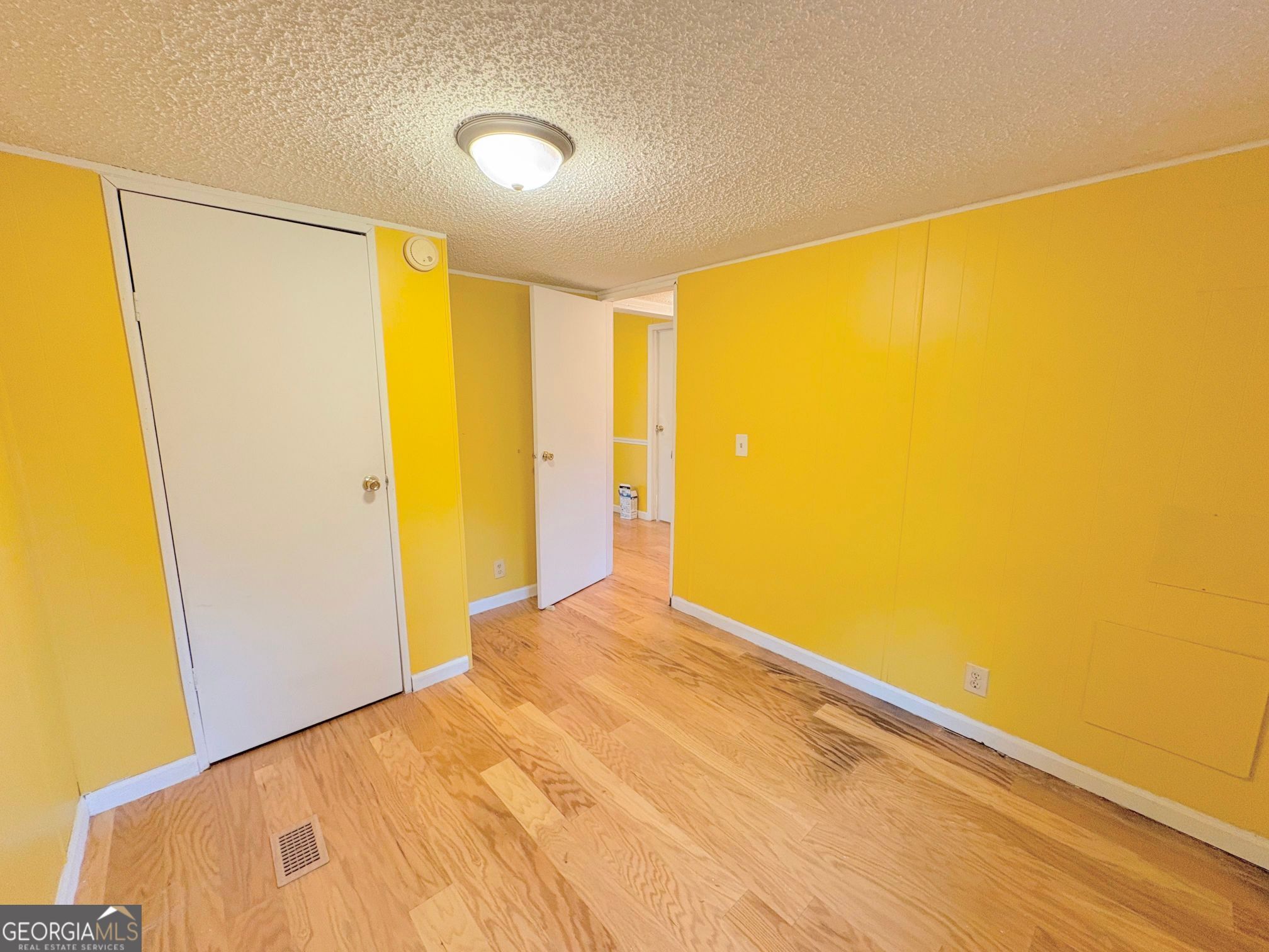 319 Wages Road Auburn, GA 30011 - Photo 25 of 26 a view of a big room with wooden floor and windows
