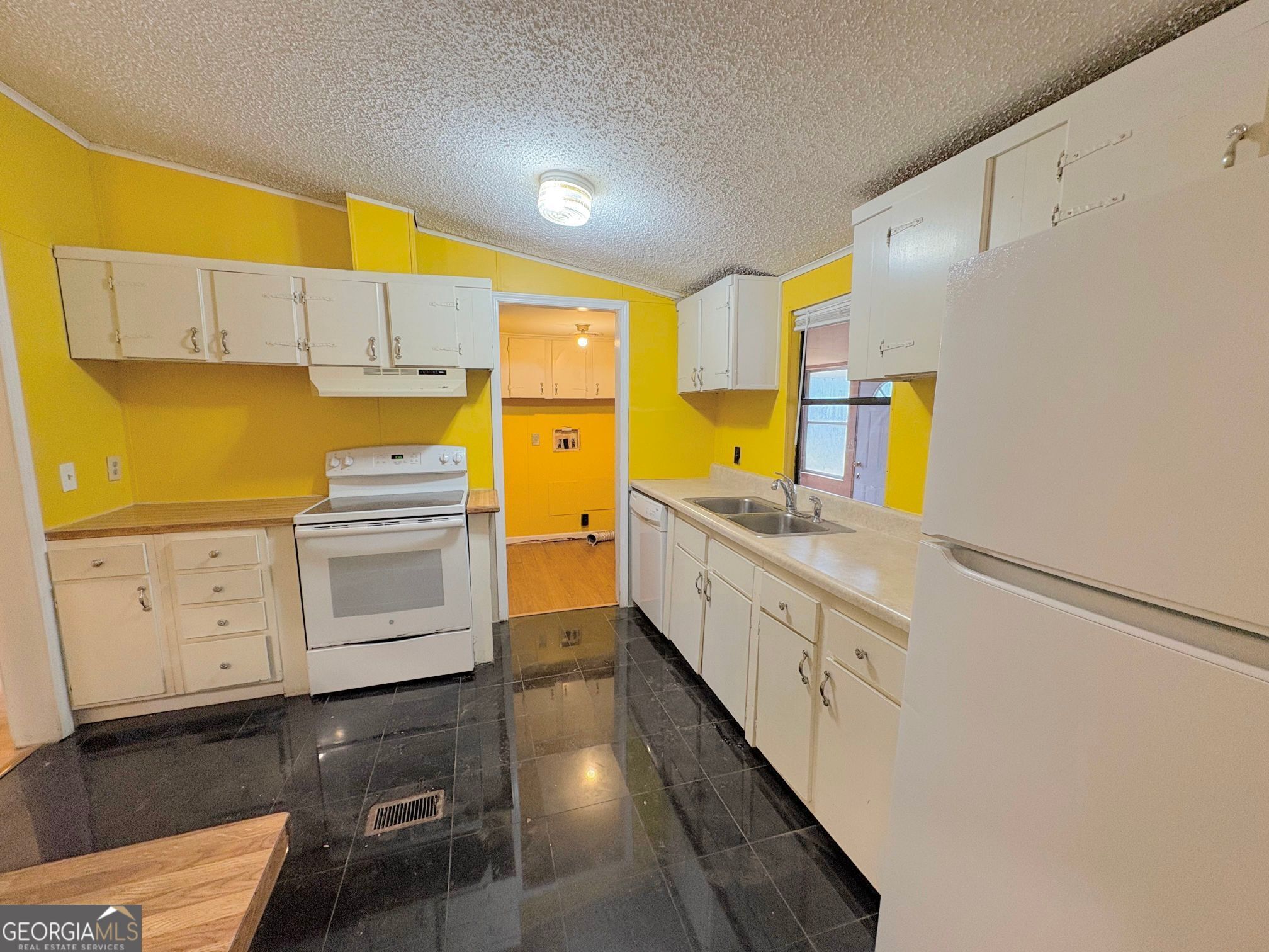 319 Wages Road Auburn, GA 30011 - Photo 10 of 26 a kitchen with cabinets a sink and appliances