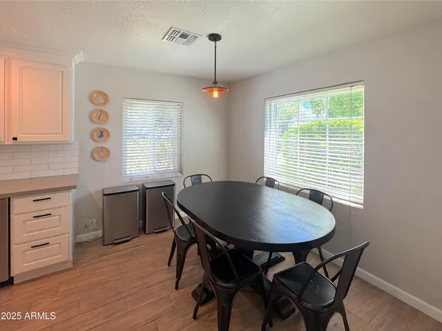 a dining room with furniture and window