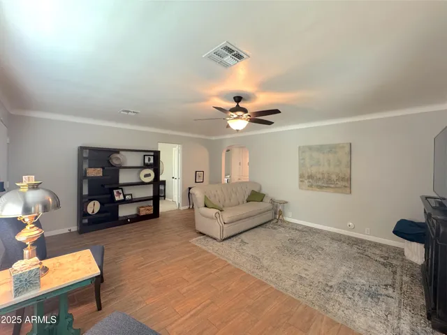 a living room with furniture and wooden floor
