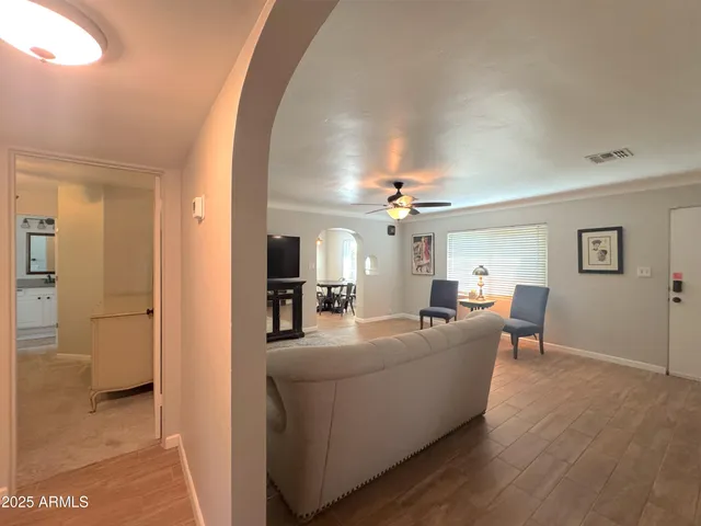 a living room with furniture and a chandelier