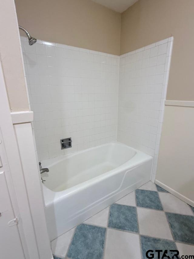 534 Fair Lane Tyler, TX 75701 - Photo 18 of 30 a white bath tub sitting next to a white sink and vanity