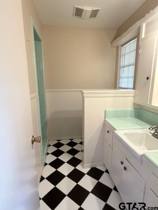 534 Fair Lane Tyler, TX 75701 - Photo 23 of 30 a bathroom with a granite countertop sink and mirror