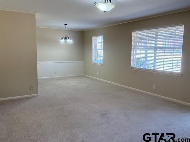 534 Fair Lane Tyler, TX 75701 - Photo 3 of 30 en empty room with windows and chandelier fan