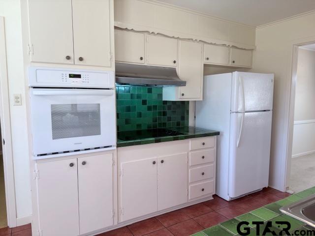 534 Fair Lane Tyler, TX 75701 - Photo 8 of 30 a kitchen with granite countertop white cabinets and white appliances