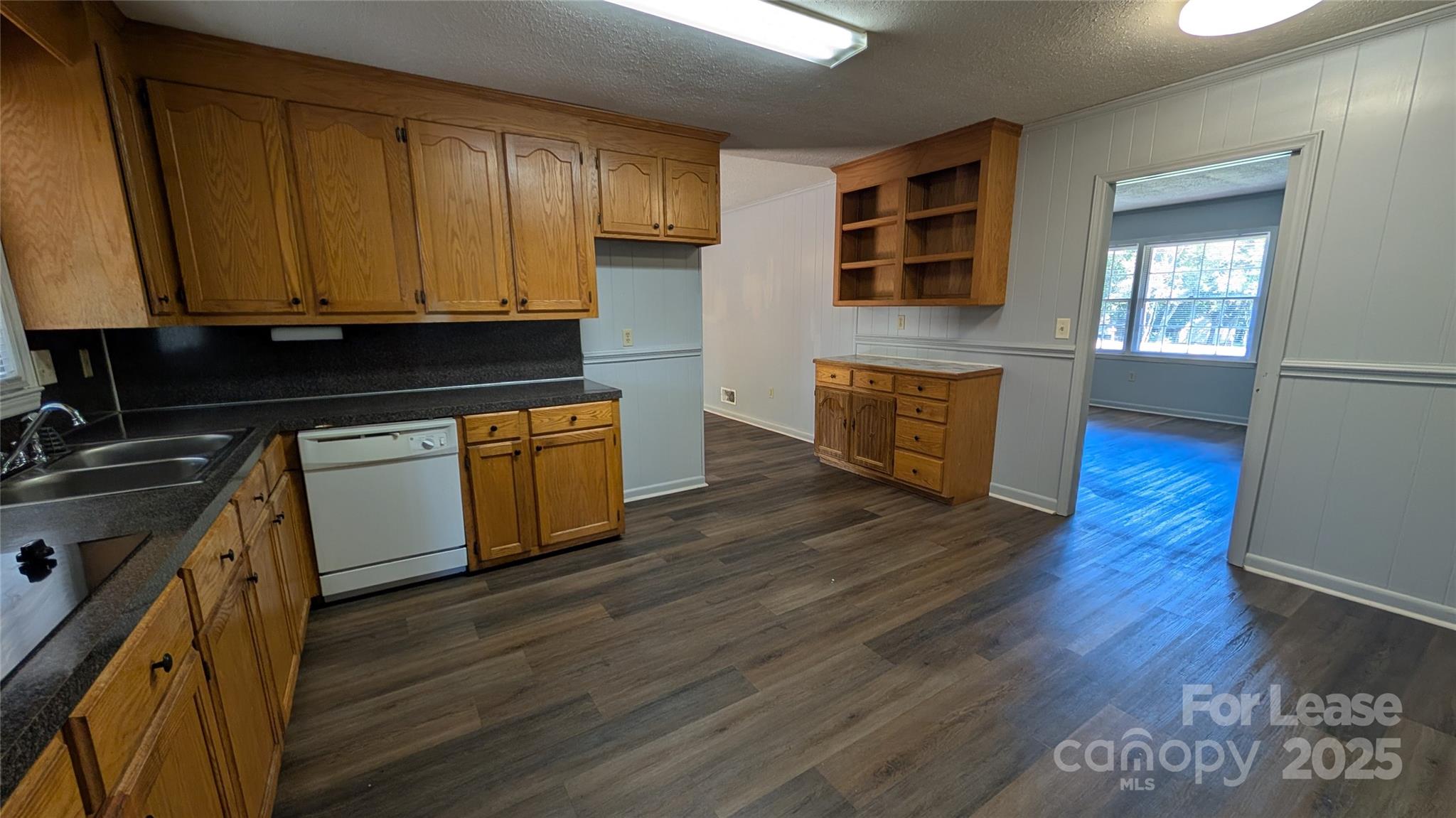 3889 Poplar Tent Road Concord, NC 28027 - Photo 11 of 33 a kitchen with wooden floors and wooden cabinets