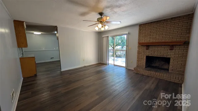 wooden floor in an empty room with a fireplace