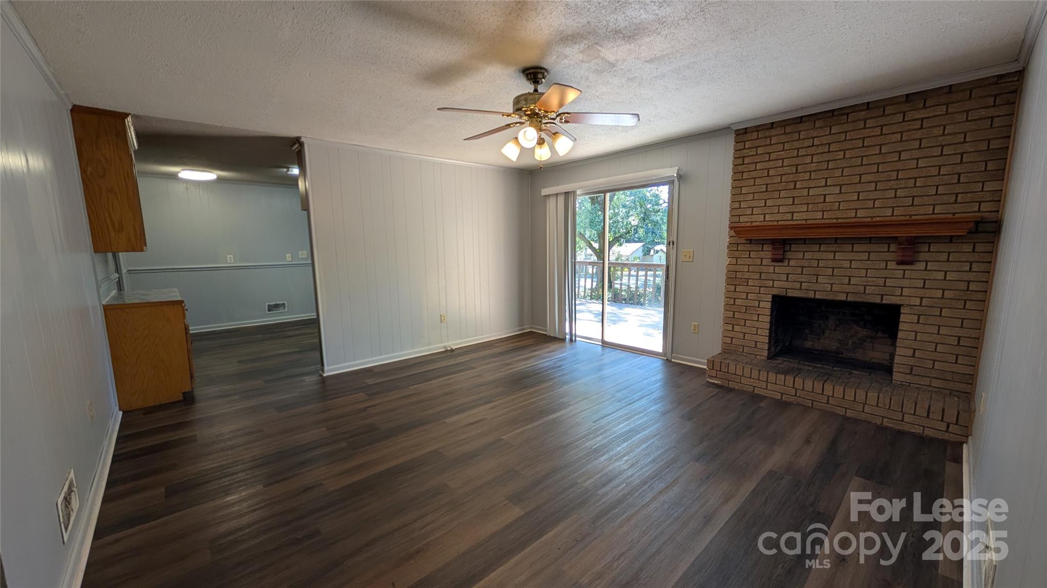3889 Poplar Tent Road Concord, NC 28027 - Photo 13 of 33 wooden floor in an empty room with a fireplace