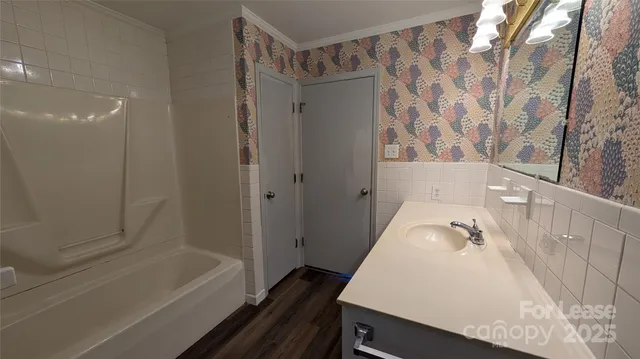 a bathroom with a bathtub and a shower