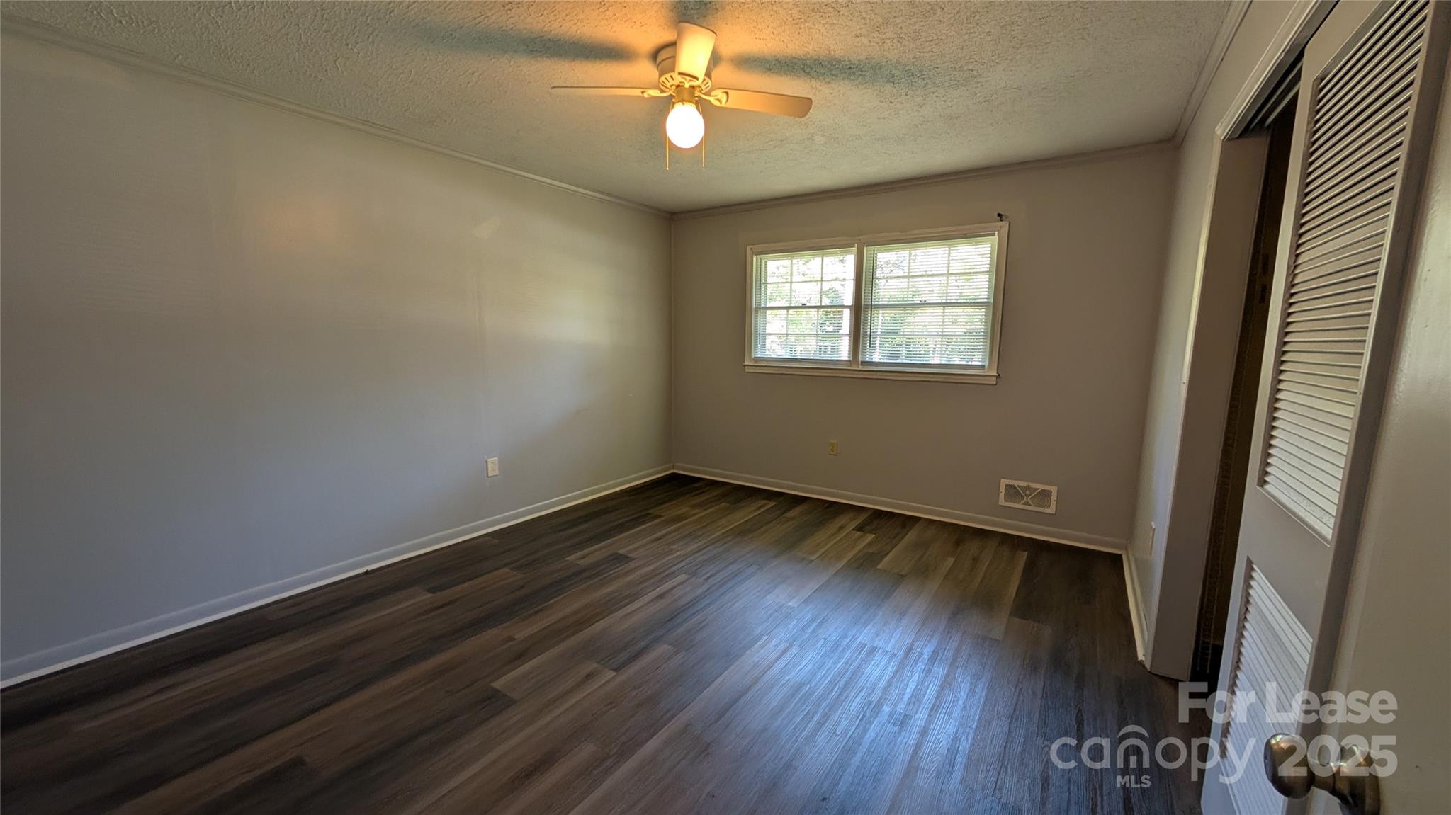 3889 Poplar Tent Road Concord, NC 28027 - Photo 17 of 33 an empty room with wooden floor and windows