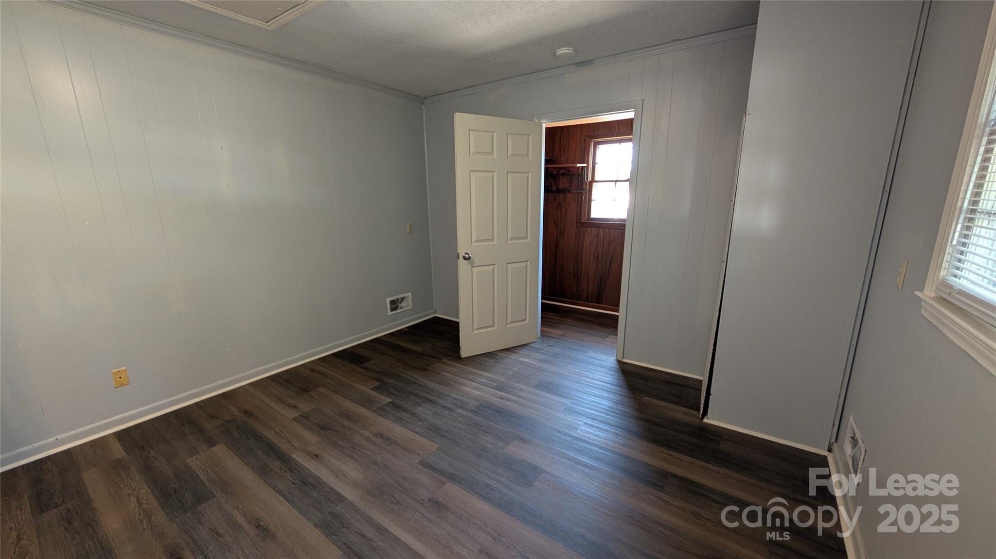 3889 Poplar Tent Road Concord, NC 28027 - Photo 24 of 33 an empty room with wooden floor and windows
