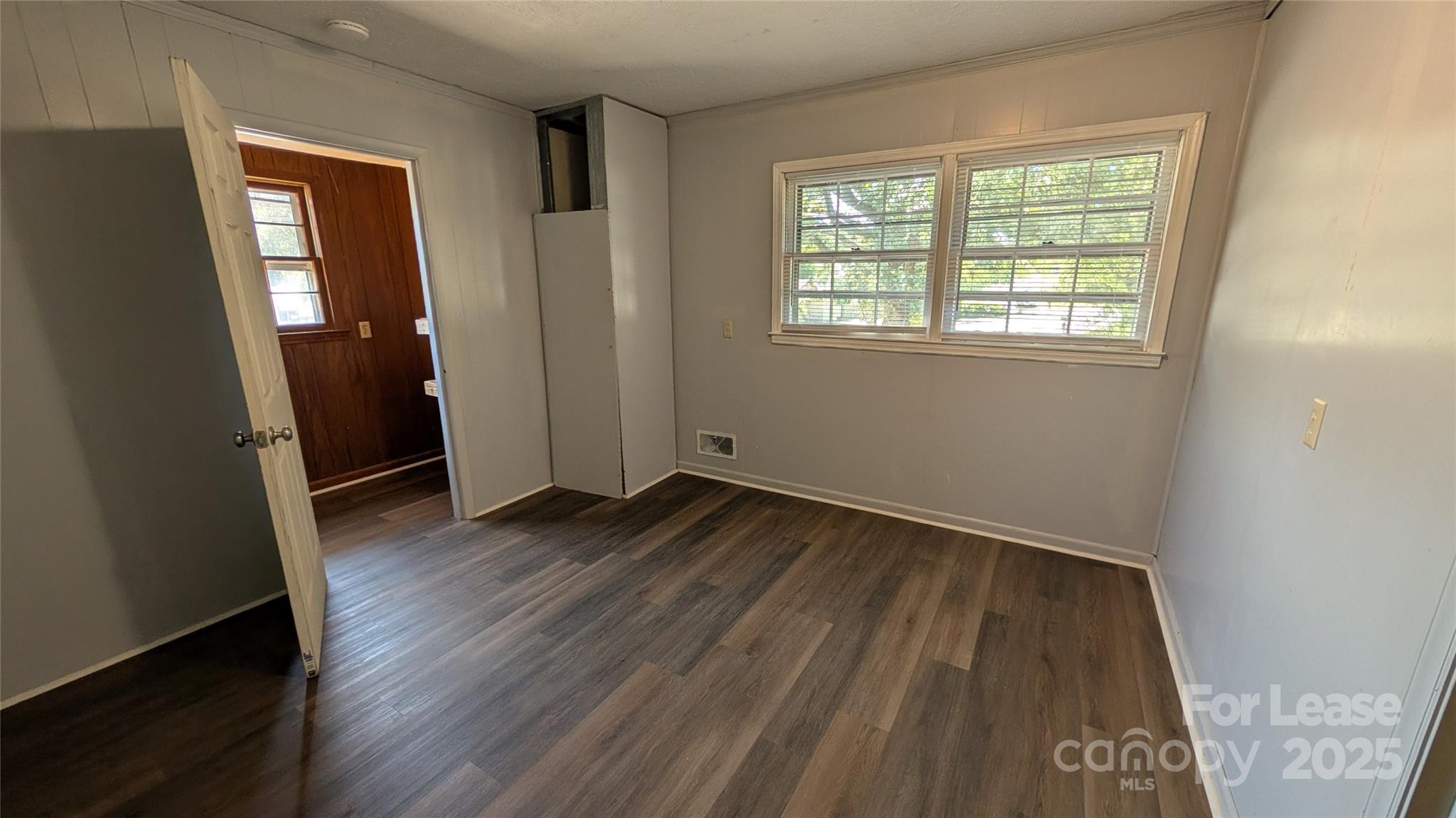 3889 Poplar Tent Road Concord, NC 28027 - Photo 25 of 33 an empty room with wooden floor and windows