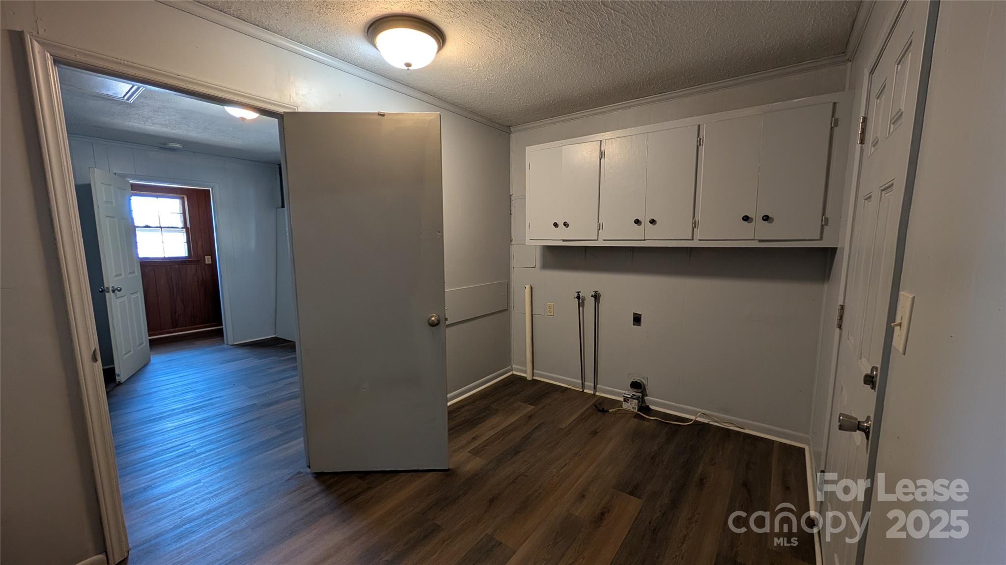 3889 Poplar Tent Road Concord, NC 28027 - Photo 27 of 33 a view of an empty room with wooden floor