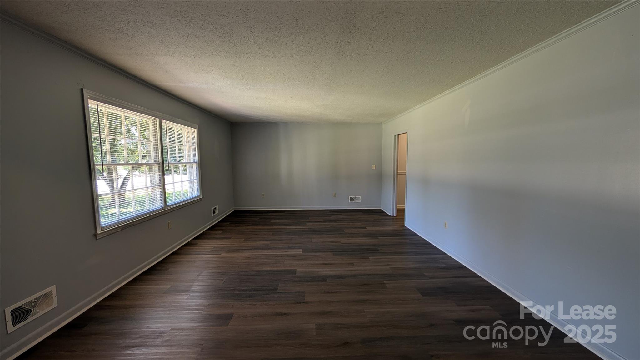 3889 Poplar Tent Road Concord, NC 28027 - Photo 5 of 33 an empty room with wooden floor and windows
