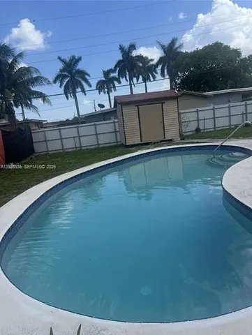 a view of a swimming pool with a yard