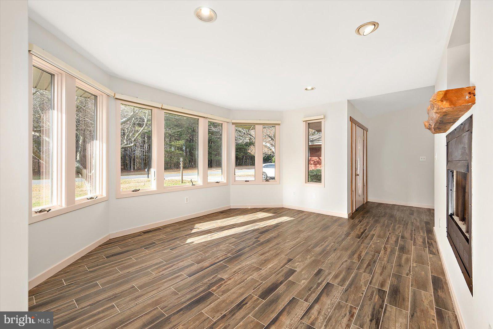 8814 Hunting Hound Road Berlin, MD 21811 - Photo 12 of 65 a view of empty room with wooden floor and fan