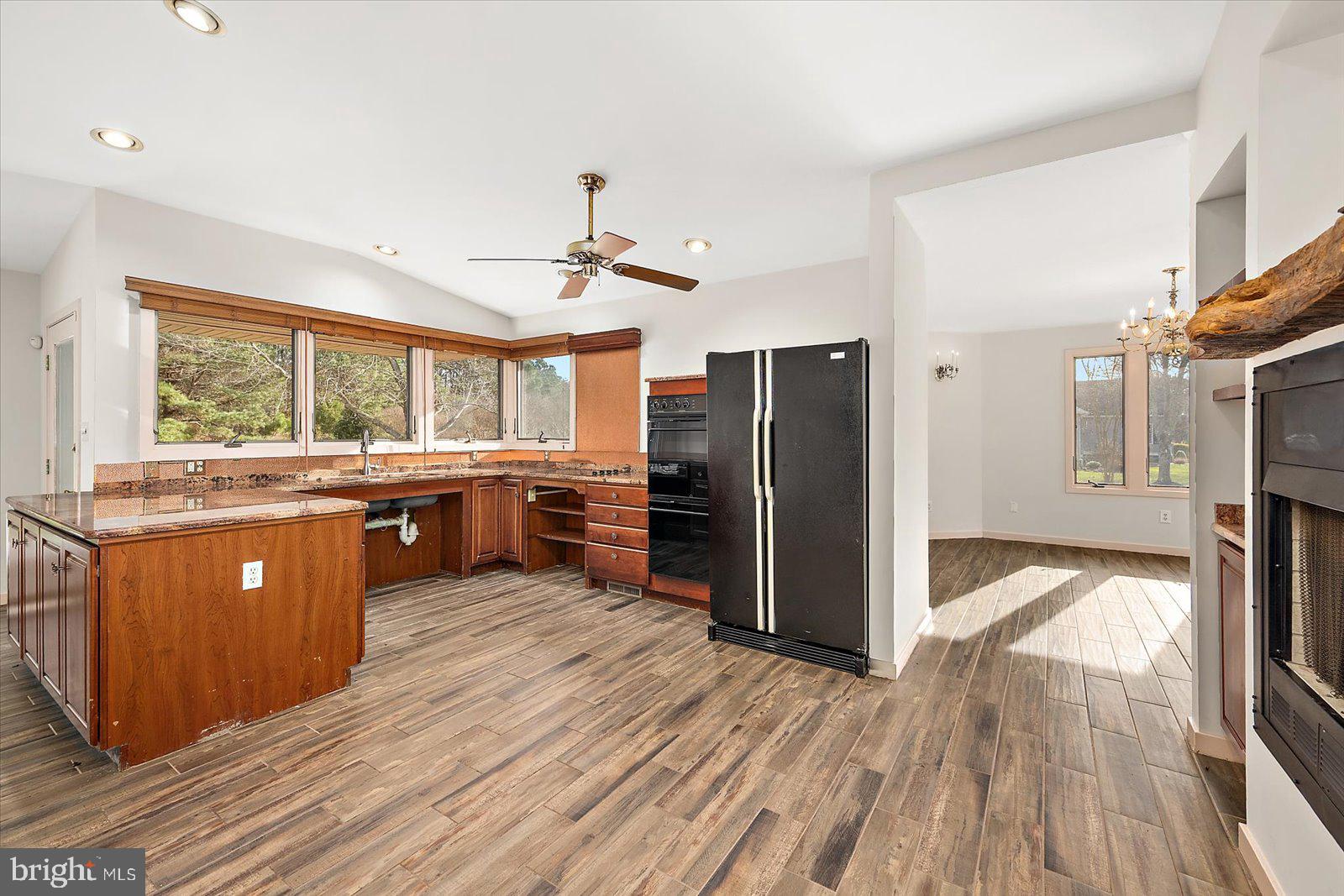 8814 Hunting Hound Road Berlin, MD 21811 - Photo 21 of 65 a kitchen with stainless steel appliances a refrigerator a sink dishwasher a stove and white countertops with wooden floor