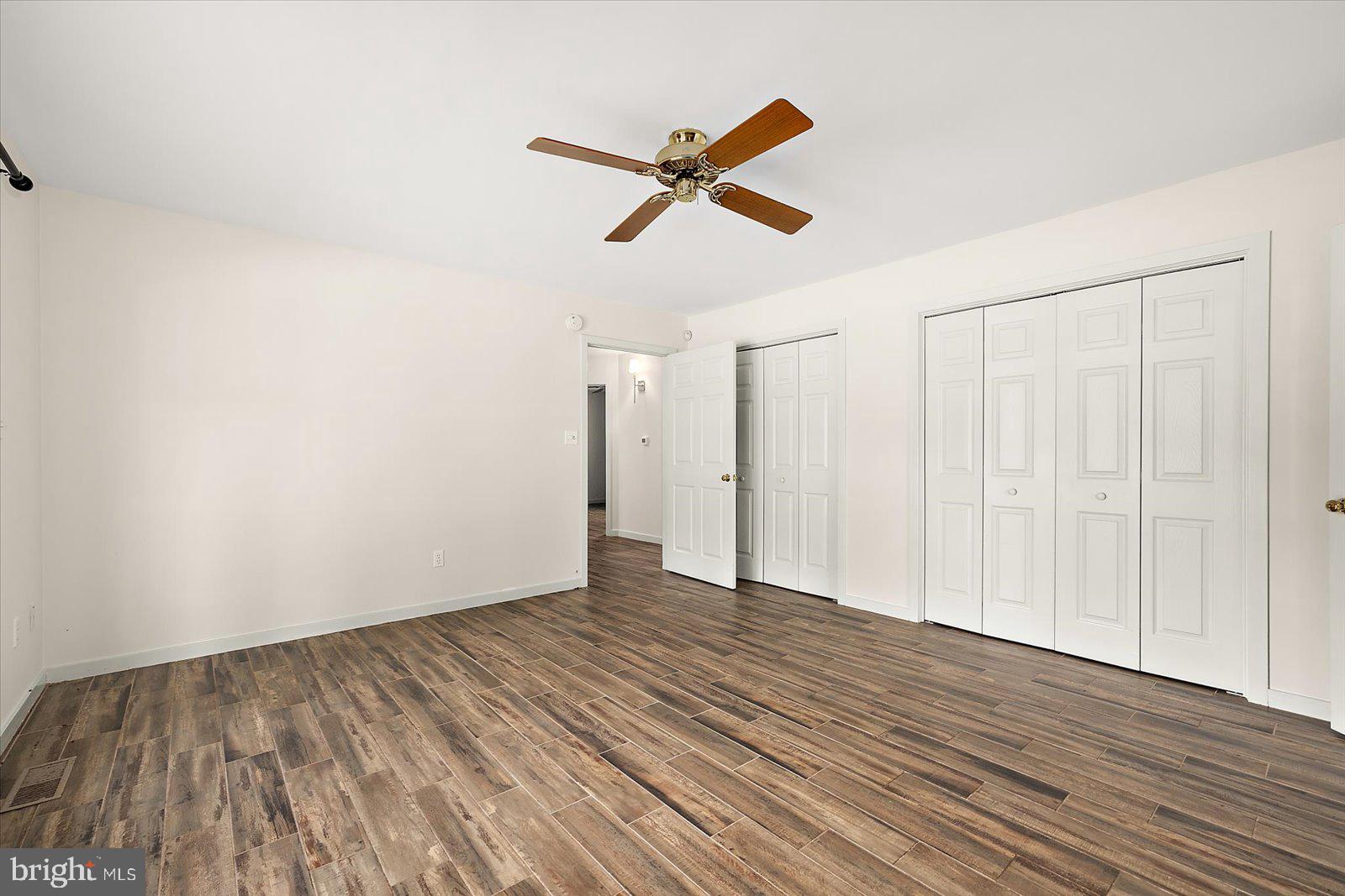 8814 Hunting Hound Road Berlin, MD 21811 - Photo 33 of 65 a view of empty room with wooden floor and ceiling fan
