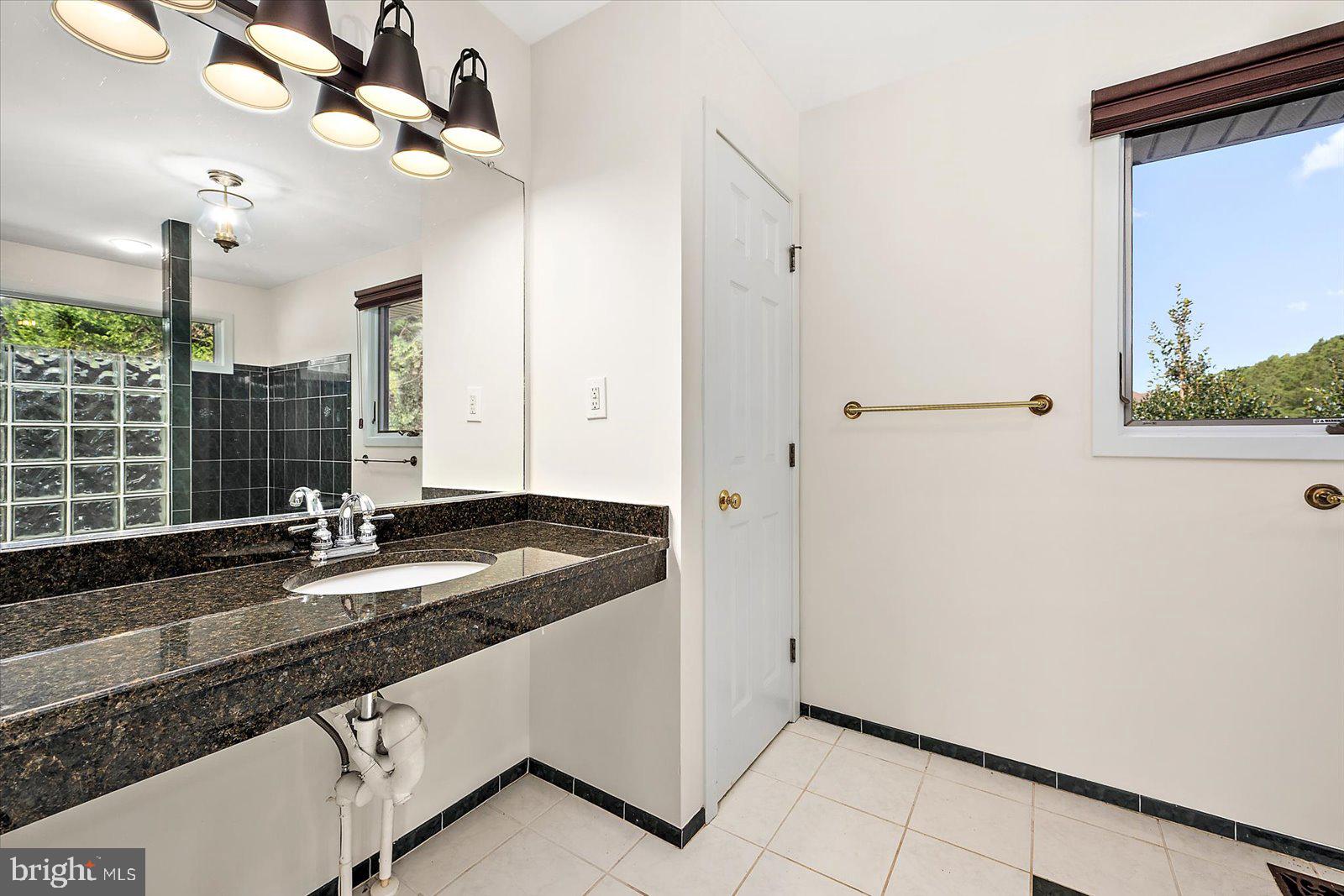 8814 Hunting Hound Road Berlin, MD 21811 - Photo 34 of 65 a kitchen with granite countertop a sink a window and stainless steel appliances
