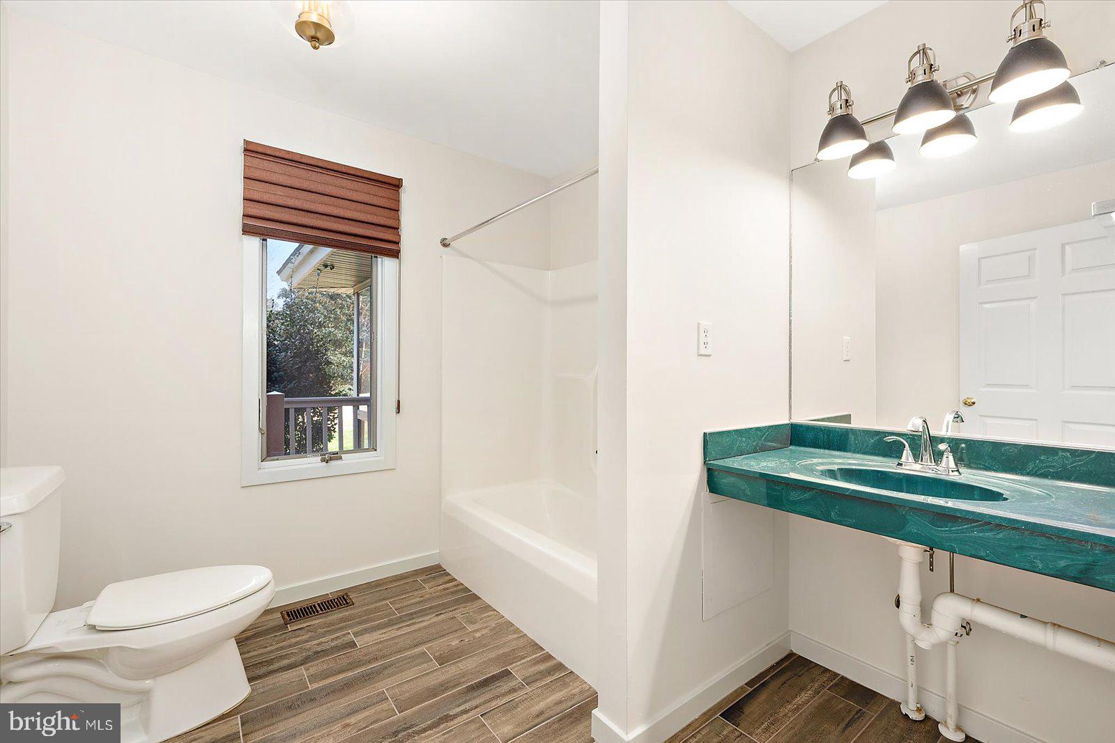 8814 Hunting Hound Road Berlin, MD 21811 - Photo 40 of 65 a bathroom with a sink a toilet and a mirror