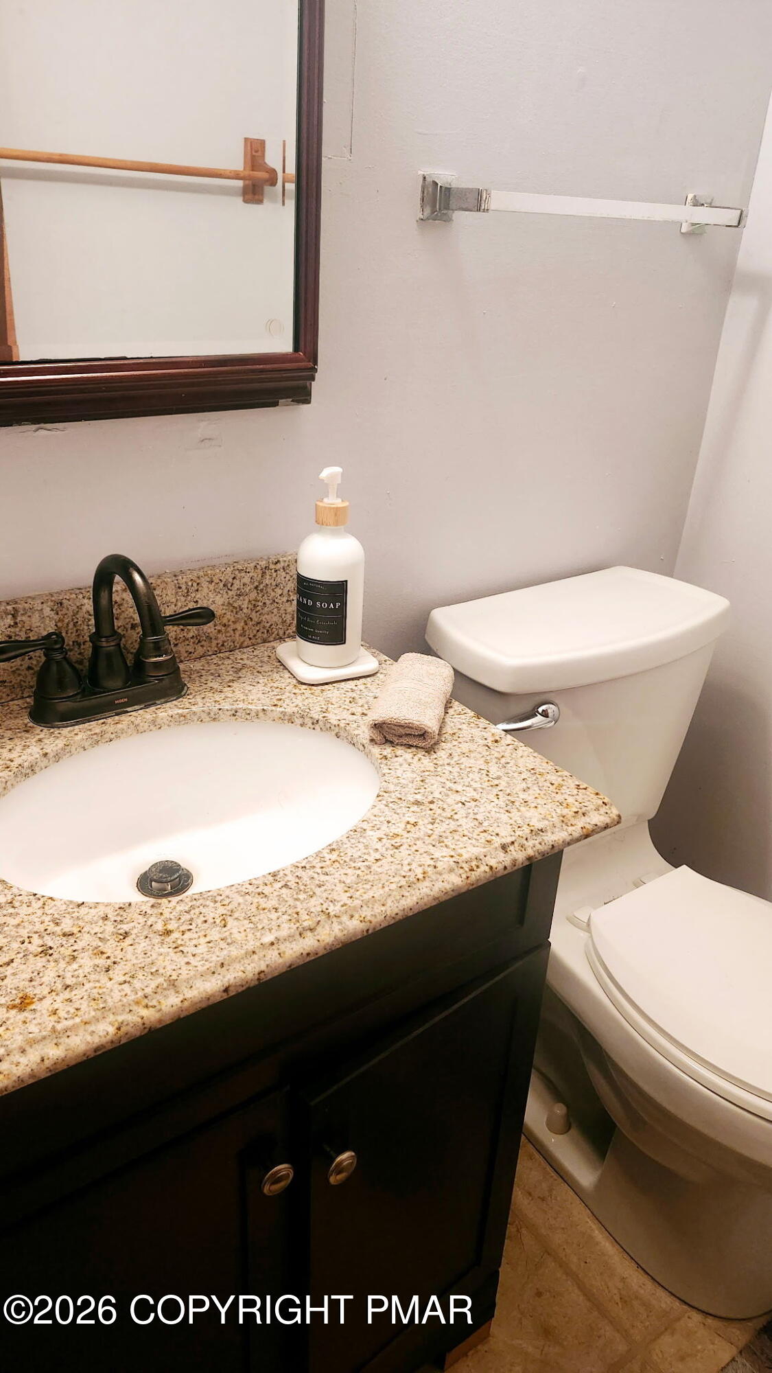 5709 Decker Road Bushkill, PA 18324 - Photo 13 of 32 a bathroom with a granite countertop toilet sink and mirror