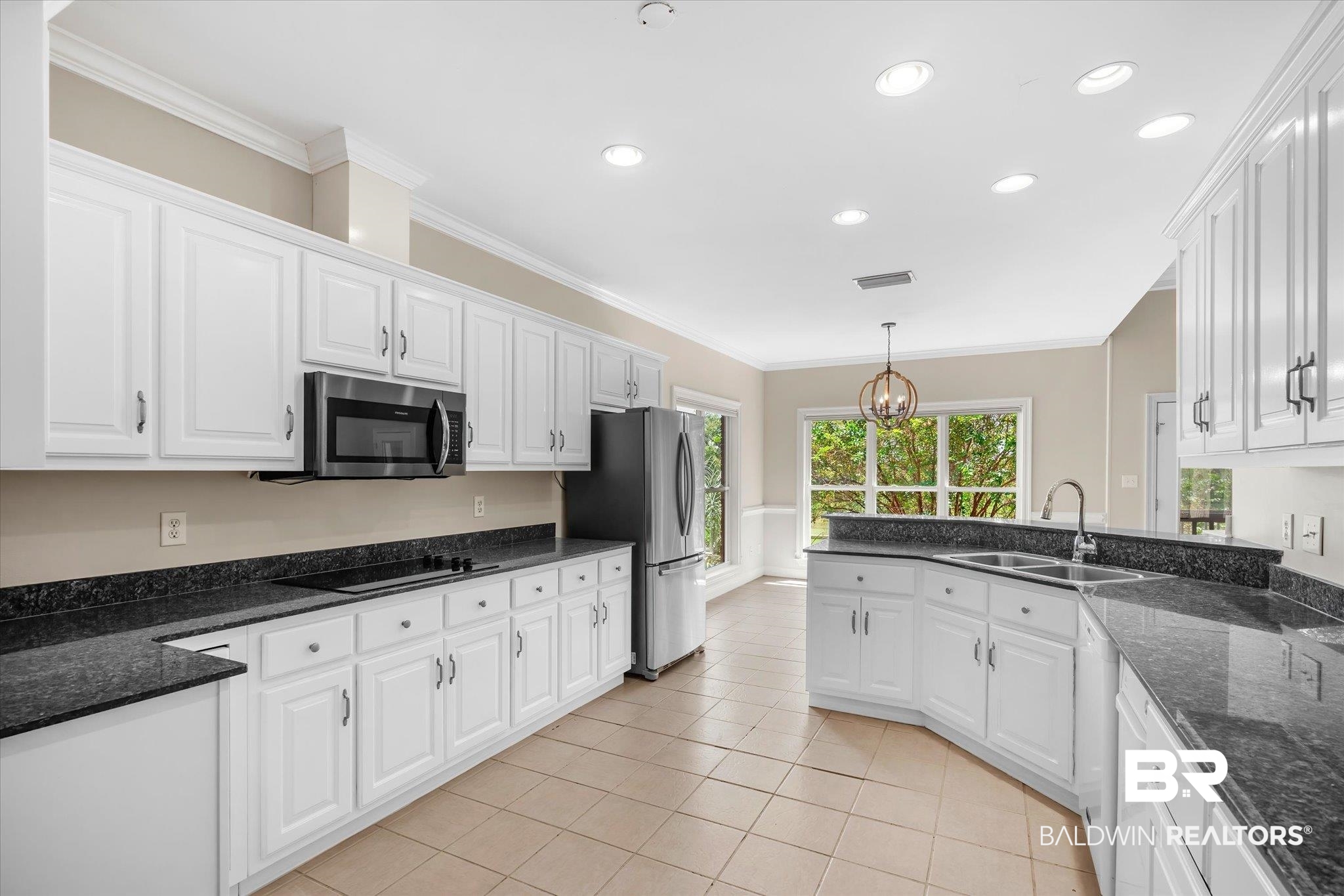 4109 Blue Heron Ridge Mobile, AL 36693 - Photo 10 of 33 Kitchen with a notable chandelier, light tile patterned floors, appliances with stainless steel finishes, sink, and white cabinets