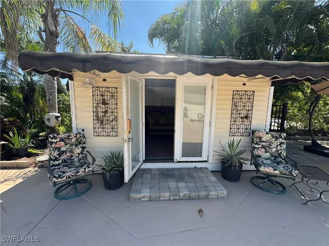 a view of patio with table and chairs under an umbrella