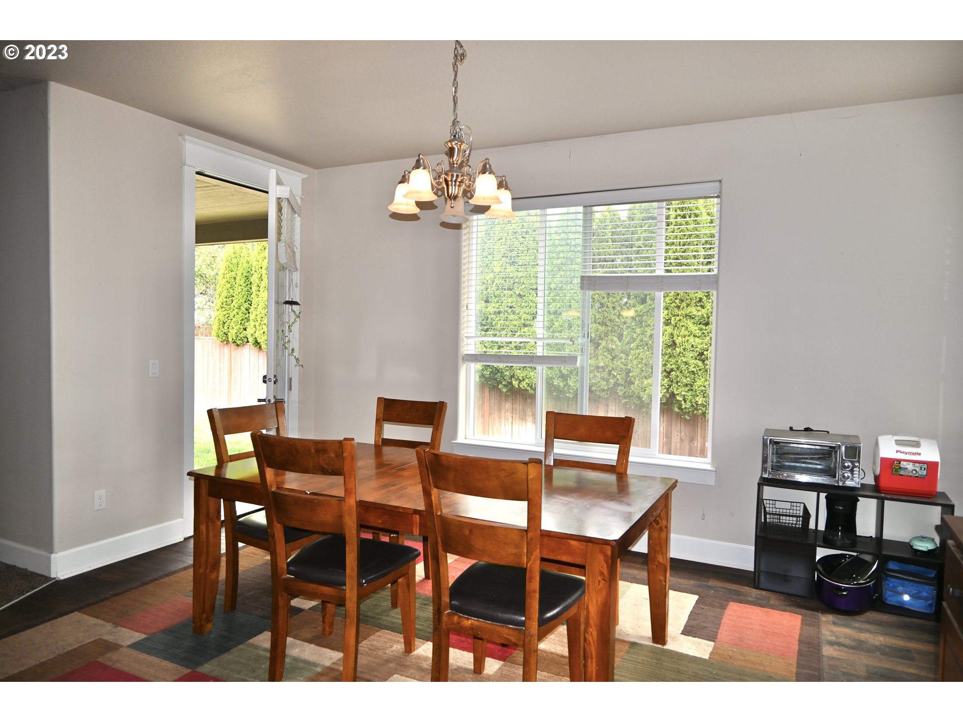 3623 Comiskey Street Forest Grove, OR 97116 - Photo 11 of 43 a dining room with furniture a chandelier and wooden floor