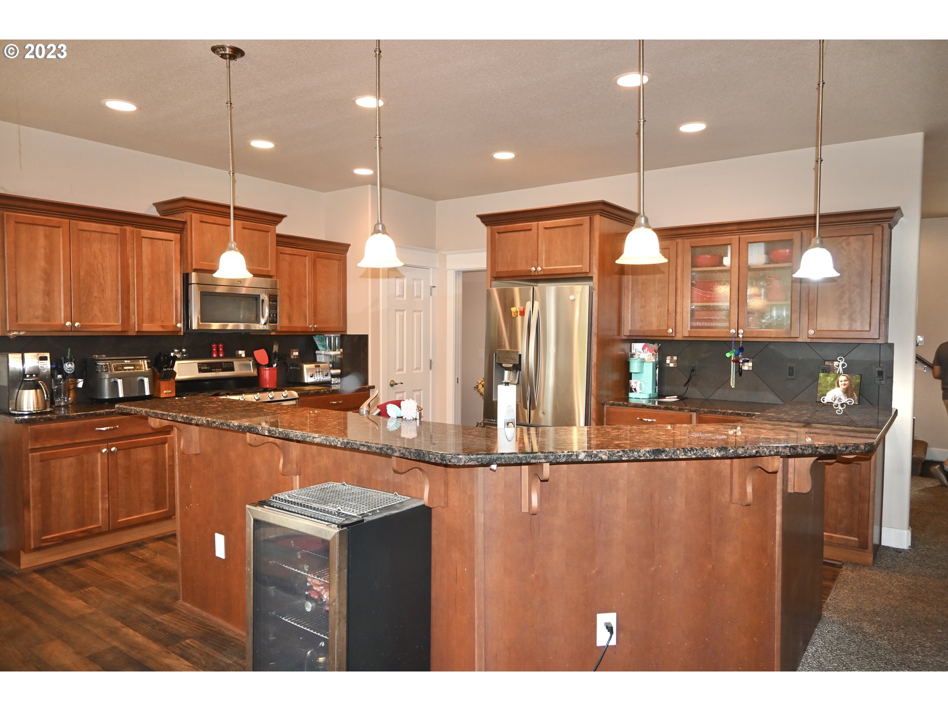 3623 Comiskey Street Forest Grove, OR 97116 - Photo 7 of 43 a kitchen with stainless steel appliances granite countertop a sink and a refrigerator