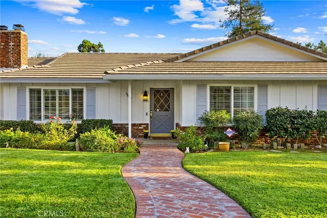 a front view of a house with a garden