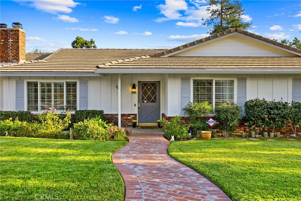 a front view of a house with a garden