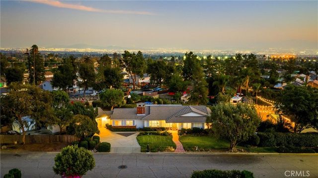 a view of a house with backyard porch and sitting area