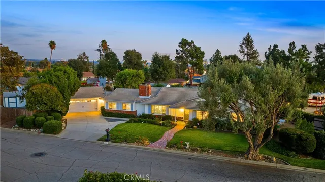 a view of a patio with a table and chairs potted plants