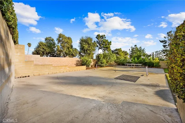 a view of a patio with dining table and chairs potted plants