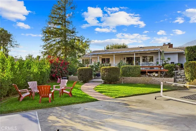 a view of a patio with a table and chairs and potted plants