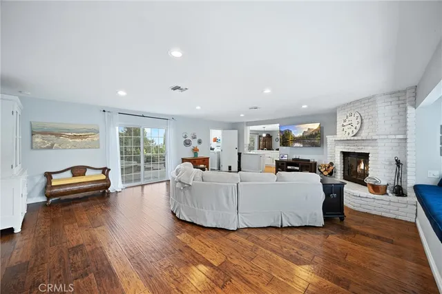 a living room with furniture a window and a fireplace