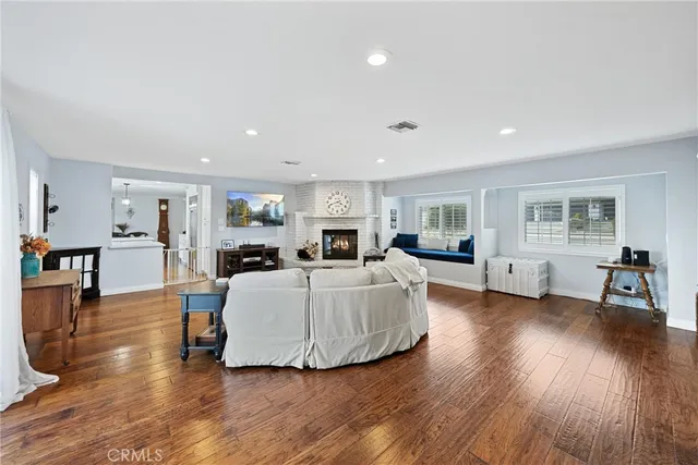 a view of a hallway with wooden floor and stairs