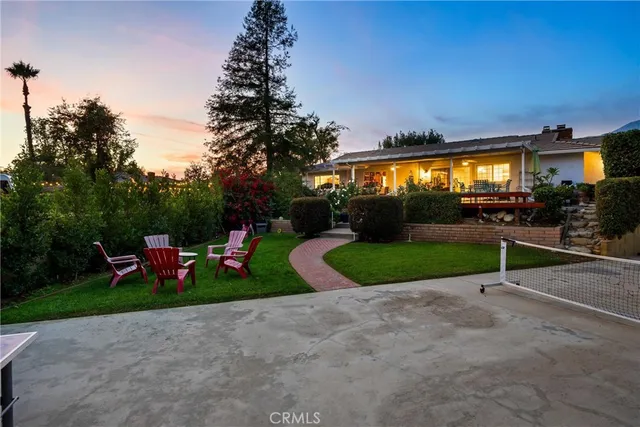 a view of a patio with a table and chairs under an umbrella