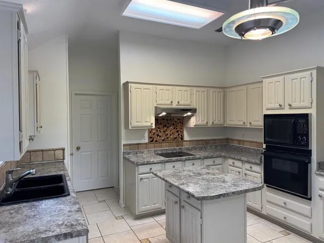 a kitchen with a stove and a refrigerator