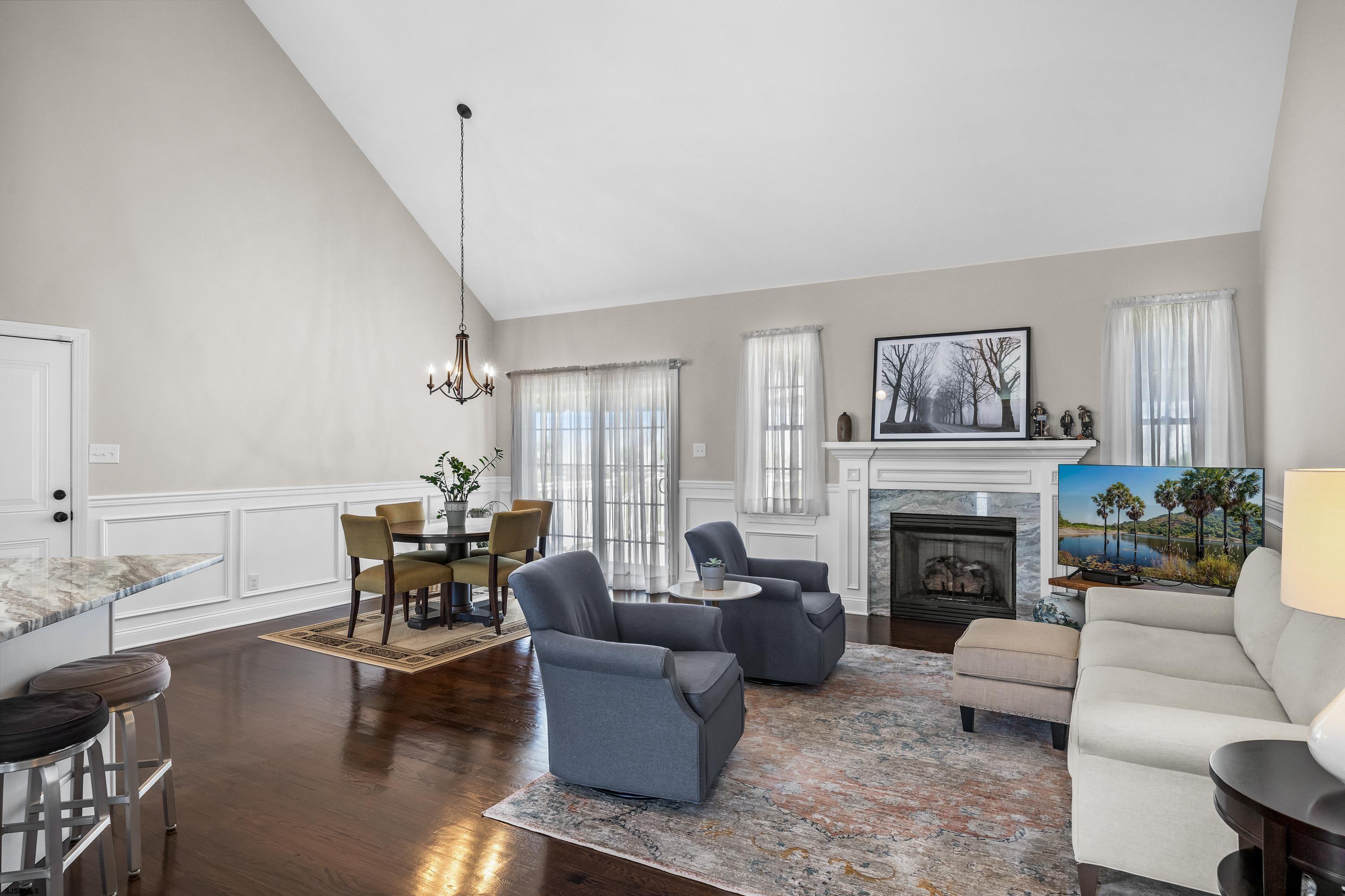 215 Surf Road Egg Harbor Township, NJ 08234 - Photo 5 of 31 a living room with furniture a fireplace and a table