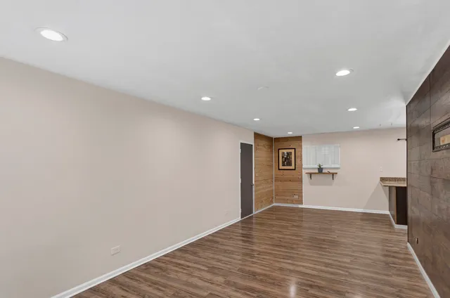 a view of a kitchen with a refrigerator and a sink